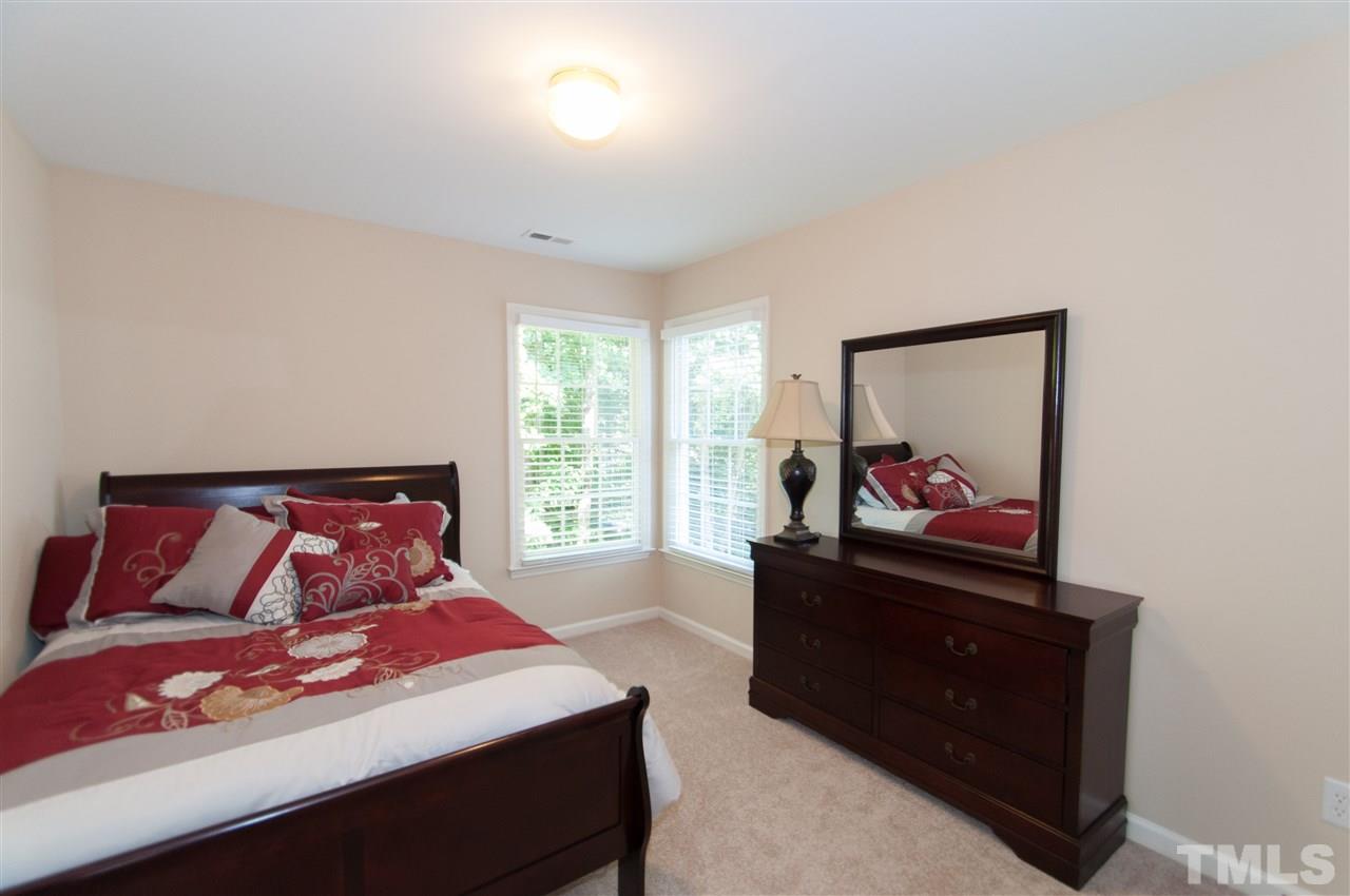 8905 Braceridge Road Raleigh, NC 27613 - Photo 20 of 25 a bedroom with a bed and a dresser