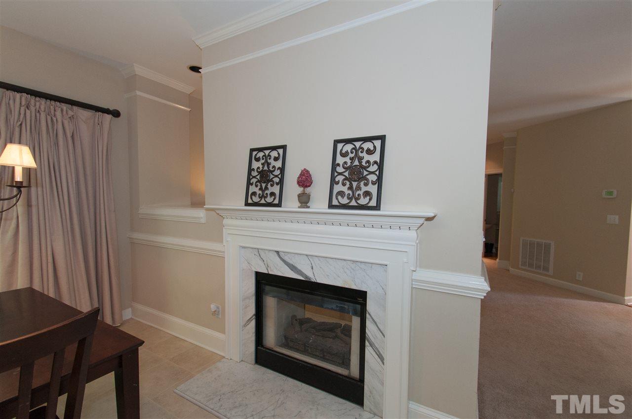 8905 Braceridge Road Raleigh, NC 27613 - Photo 3 of 25 a living room with furniture and a fireplace