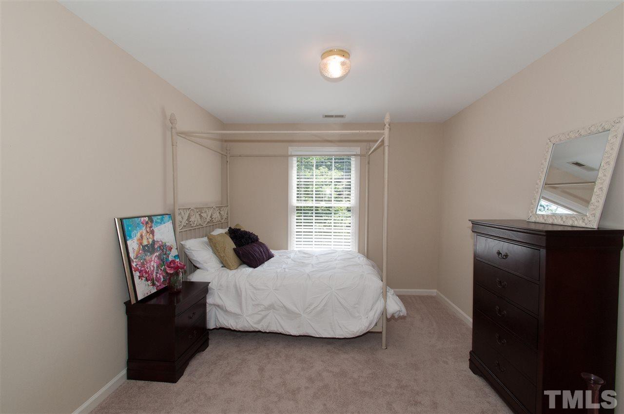 8905 Braceridge Road Raleigh, NC 27613 - Photo 21 of 25 a bedroom with a bed and a window
