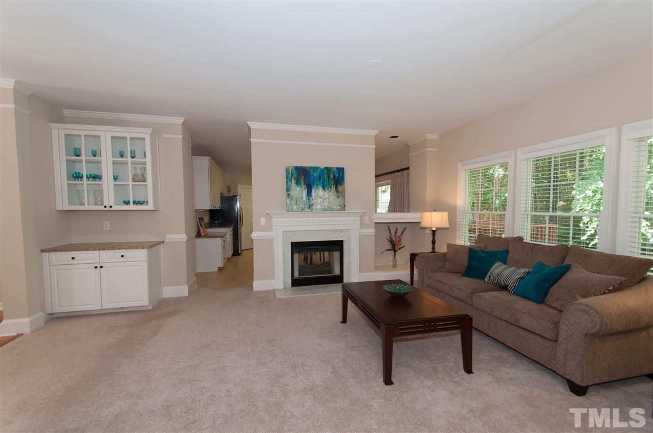 8905 Braceridge Road Raleigh, NC 27613 - Photo 6 of 25 a living room with furniture and a fireplace