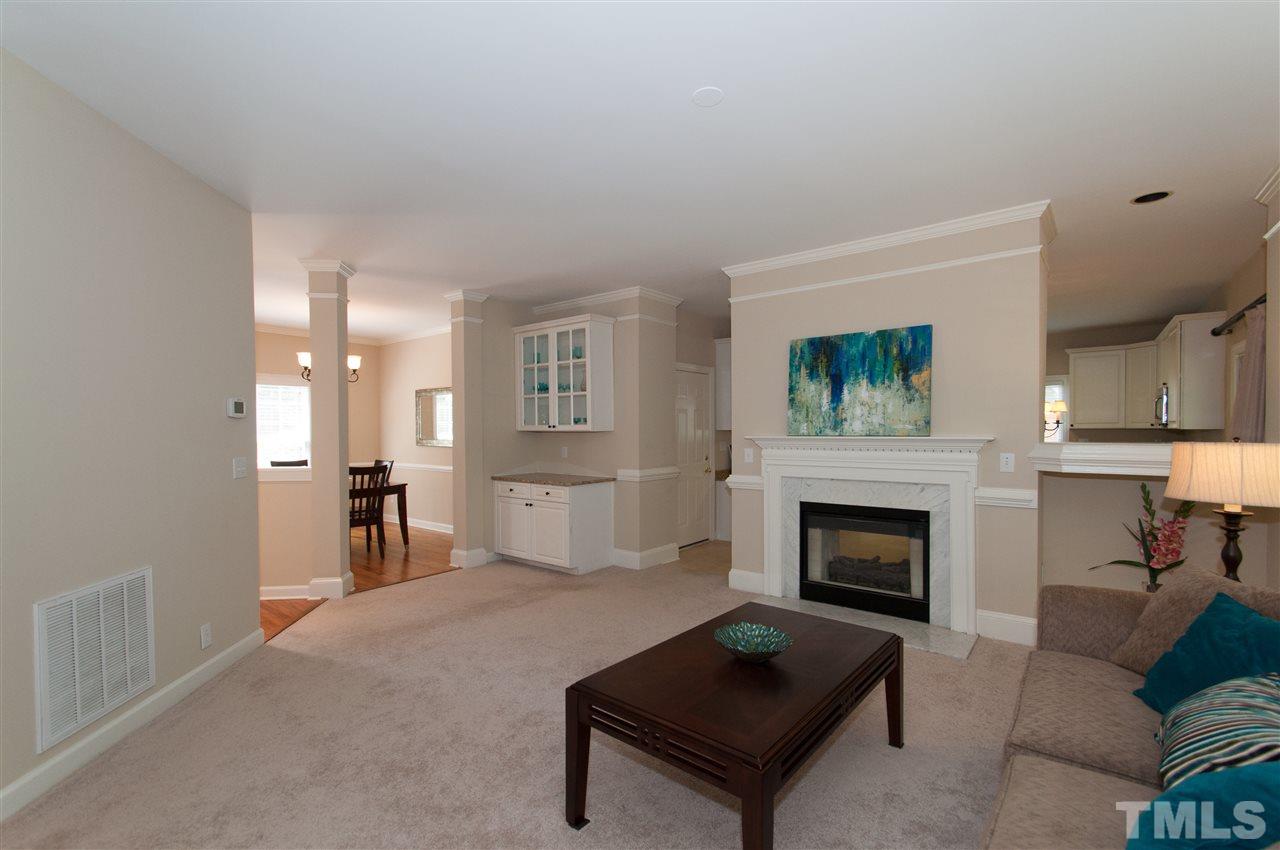 8905 Braceridge Road Raleigh, NC 27613 - Photo 7 of 25 a living room with furniture and a fireplace