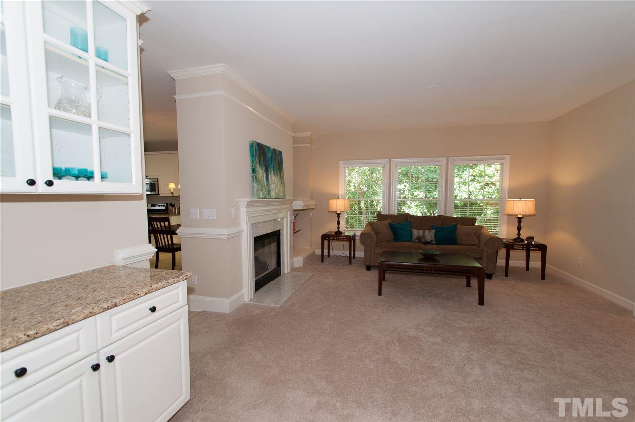 8905 Braceridge Road Raleigh, NC 27613 - Photo 8 of 25 a living room with furniture and a fireplace