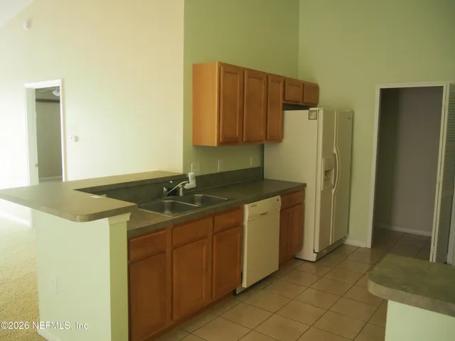 a kitchen with a sink and a refrigerator
