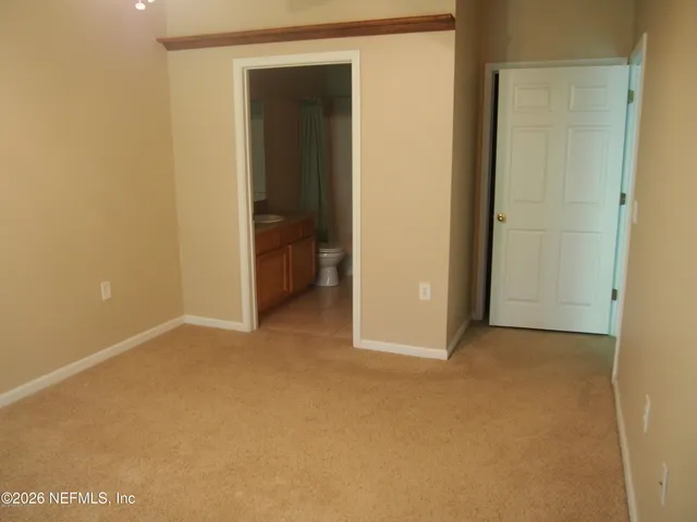 a view of an empty room and closet area