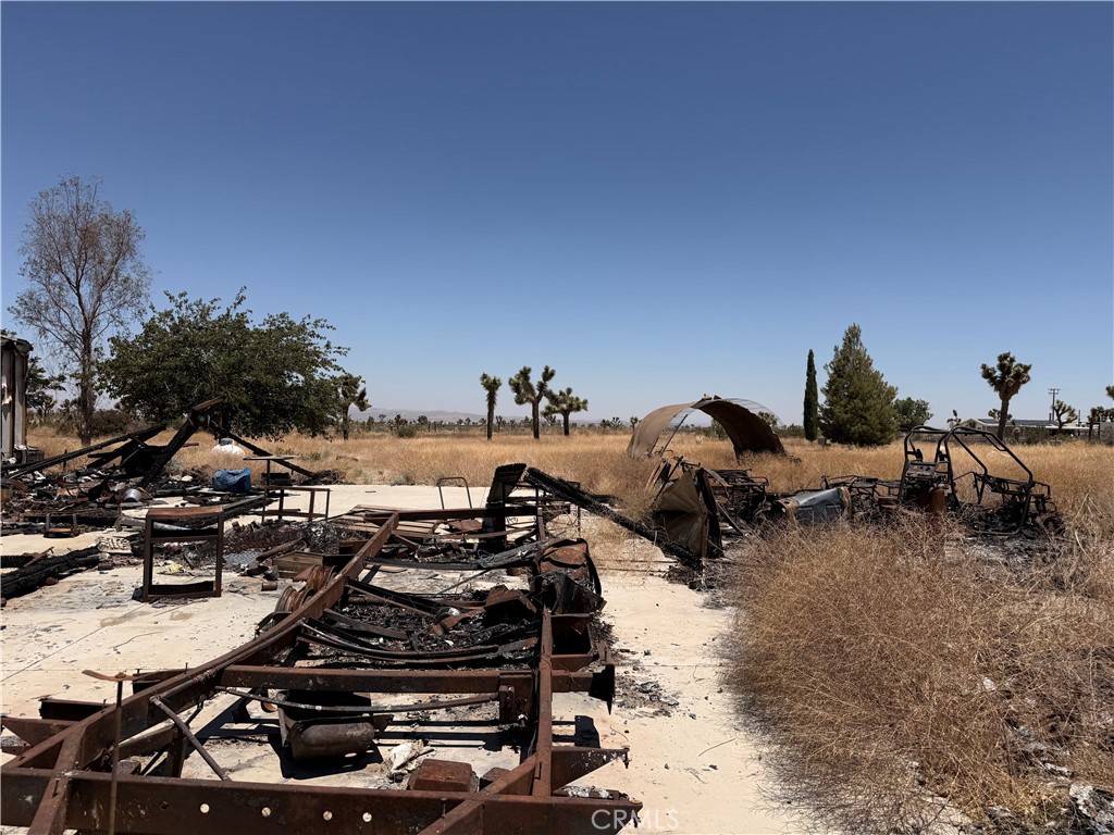 12225 Lager Road Phelan, CA 92371 - Photo 10 of 18 Burned vehicle frame and outbuildings in backyard