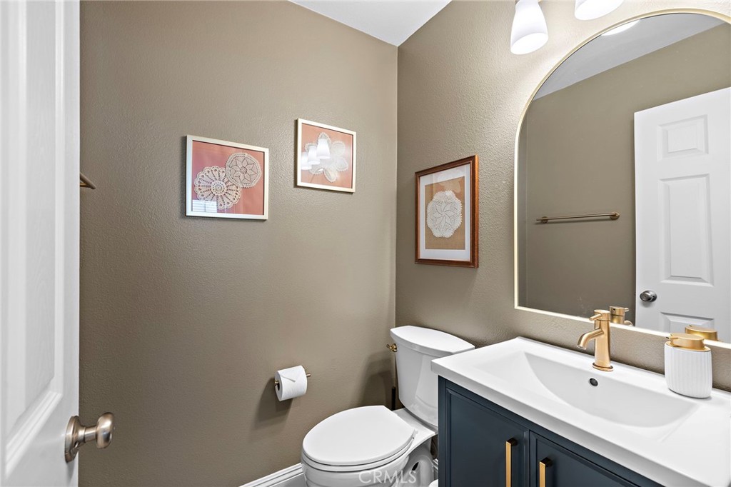 71 Sklar Street Ladera Ranch, CA 92694 - Photo 19 of 55 a bathroom with a sink mirror and toilet