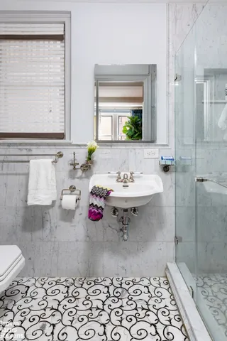 a bathroom with a sink toilet and shower