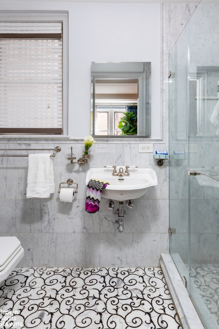 325 East 79th Street, Unit 3E Manhattan, NY 10075 - Photo 10 of 14 a bathroom with a sink toilet and shower