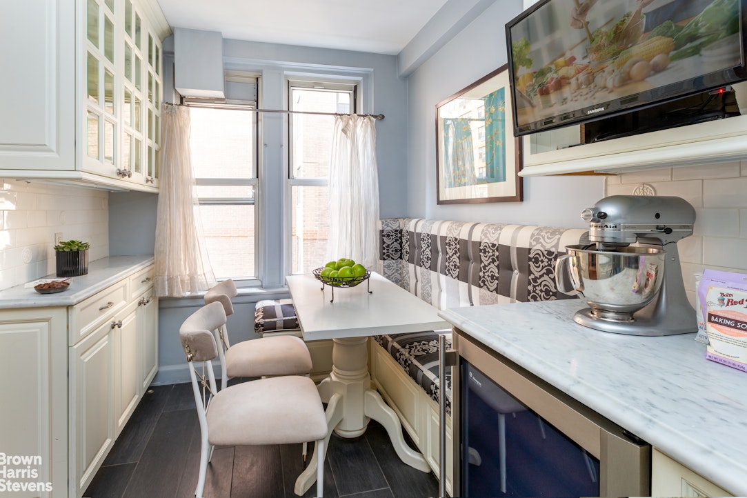 325 East 79th Street, Unit 3E Manhattan, NY 10075 - Photo 7 of 14 a dining hall with stainless steel appliances granite countertop a stove a sink and a microwave