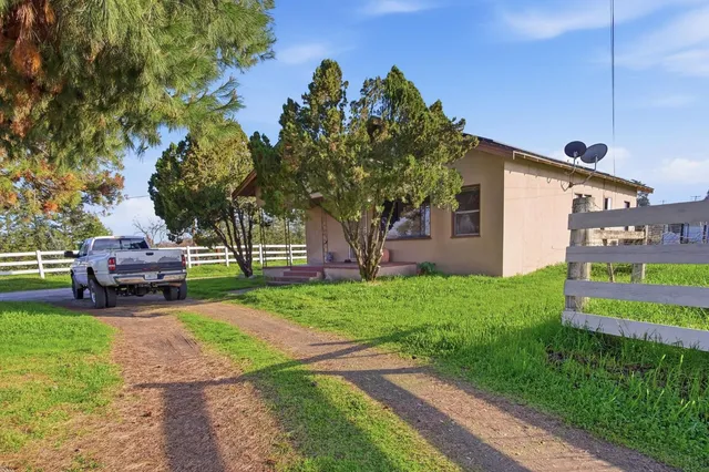 a house view with a sitting space and garden