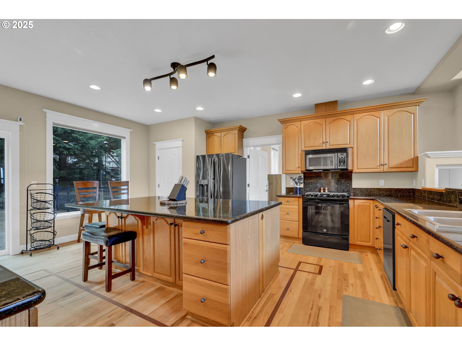 2375 Lasater Boulevard Eugene, OR 97405 - Photo 11 of 46 a kitchen with stainless steel appliances kitchen island granite countertop a stove top oven a sink a dining table and chairs