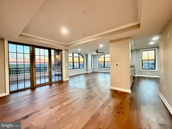 a kitchen with stainless steel appliances kitchen island granite countertop a sink stove and refrigerator