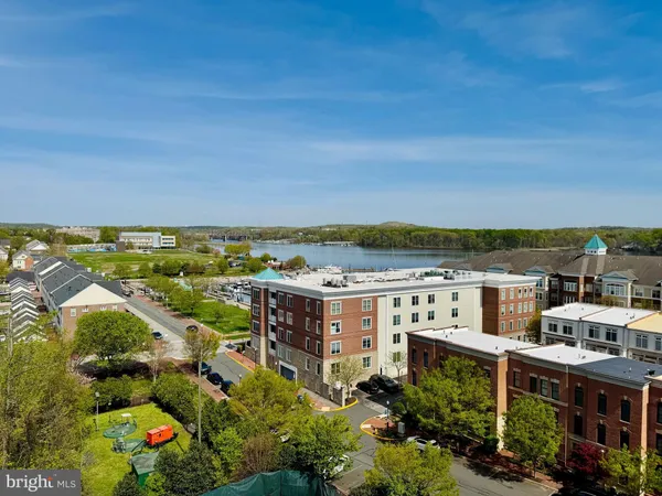 an aerial view of residential houses with outdoor space and ocean view