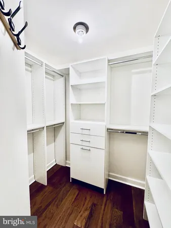 a living room with furniture and a book shelf
