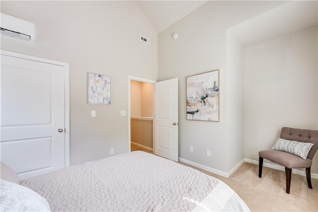 962 Lawton Street Southwest Atlanta, GA 30310 - Photo 12 of 14 a bedroom with a bed and a couch