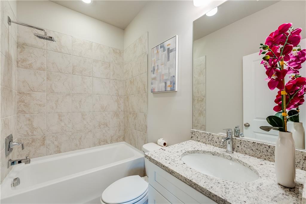 962 Lawton Street Southwest Atlanta, GA 30310 - Photo 8 of 14 a bathroom with a granite countertop sink a toilet and bathtub