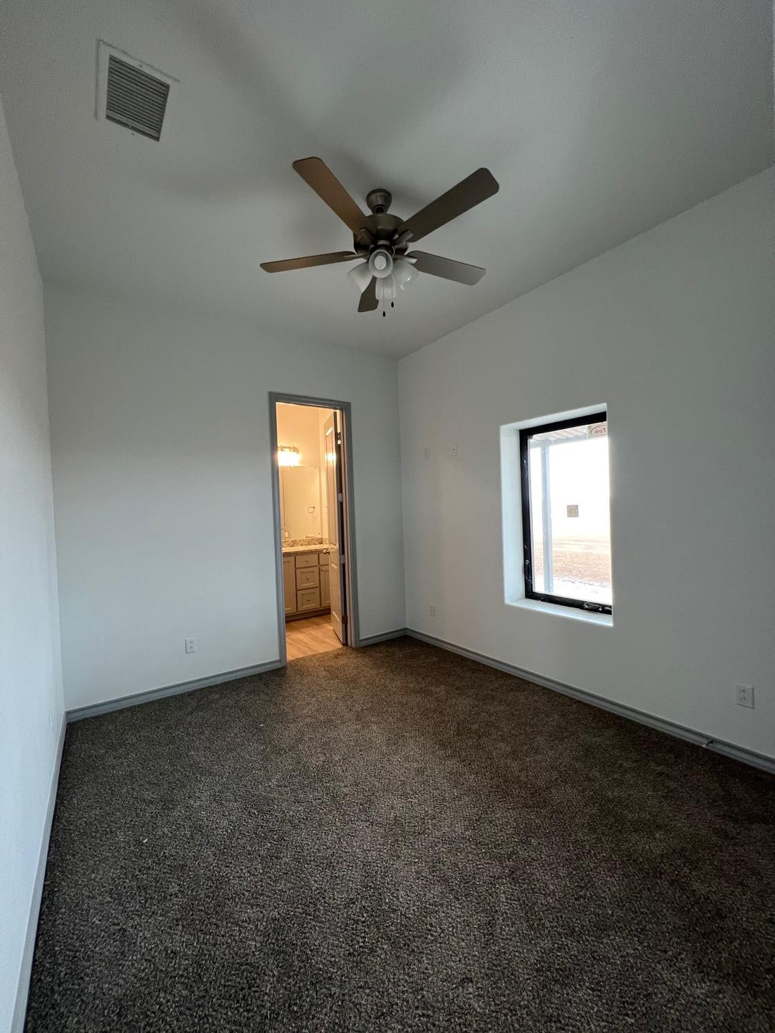 21402 County Road 2140 Lubbock, TX 79423 - Photo 14 of 23 an empty room with a window and a fan