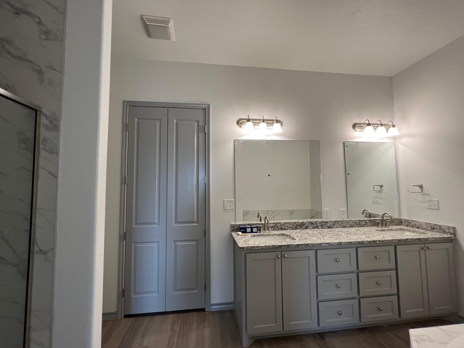 21402 County Road 2140 Lubbock, TX 79423 - Photo 19 of 23 a bathroom with a granite countertop sink and a mirror