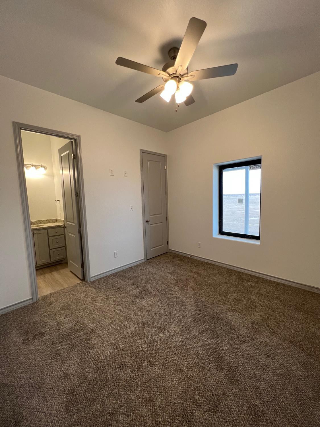 21402 County Road 2140 Lubbock, TX 79423 - Photo 21 of 23 an empty room with windows and fan