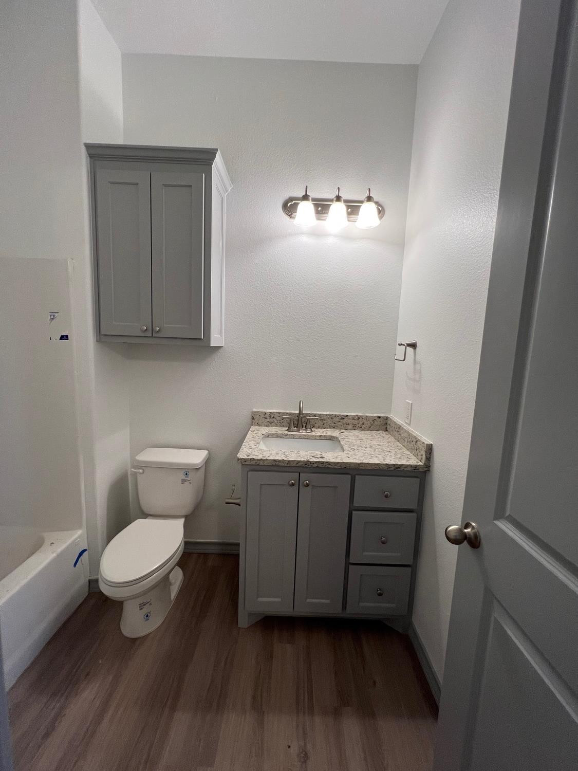 21402 County Road 2140 Lubbock, TX 79423 - Photo 22 of 23 a bathroom with a granite countertop toilet and sink
