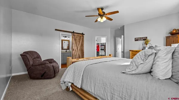 a bathroom with a granite countertop sink vanity and mirror