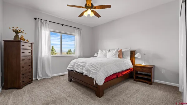 a bedroom with a bed dresser and a window