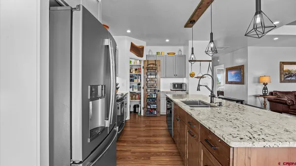 a living room with furniture flat screen tv and wooden floor