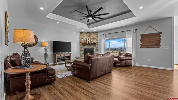 a living room with furniture a fireplace and a chandelier