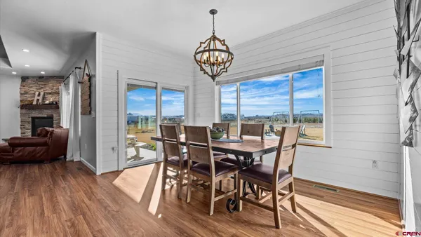 a view of a hallway with wooden floor and closet