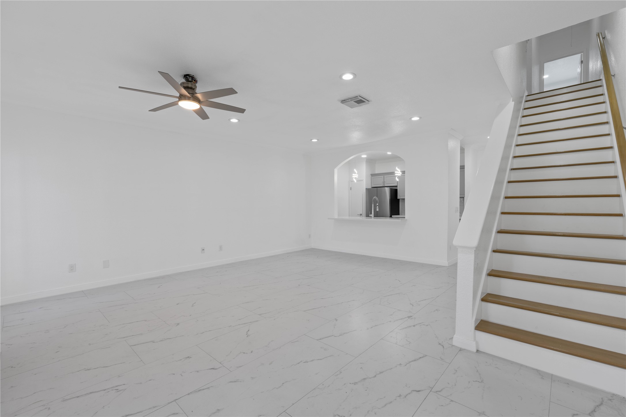wooden floor in an empty room with a ceiling fan