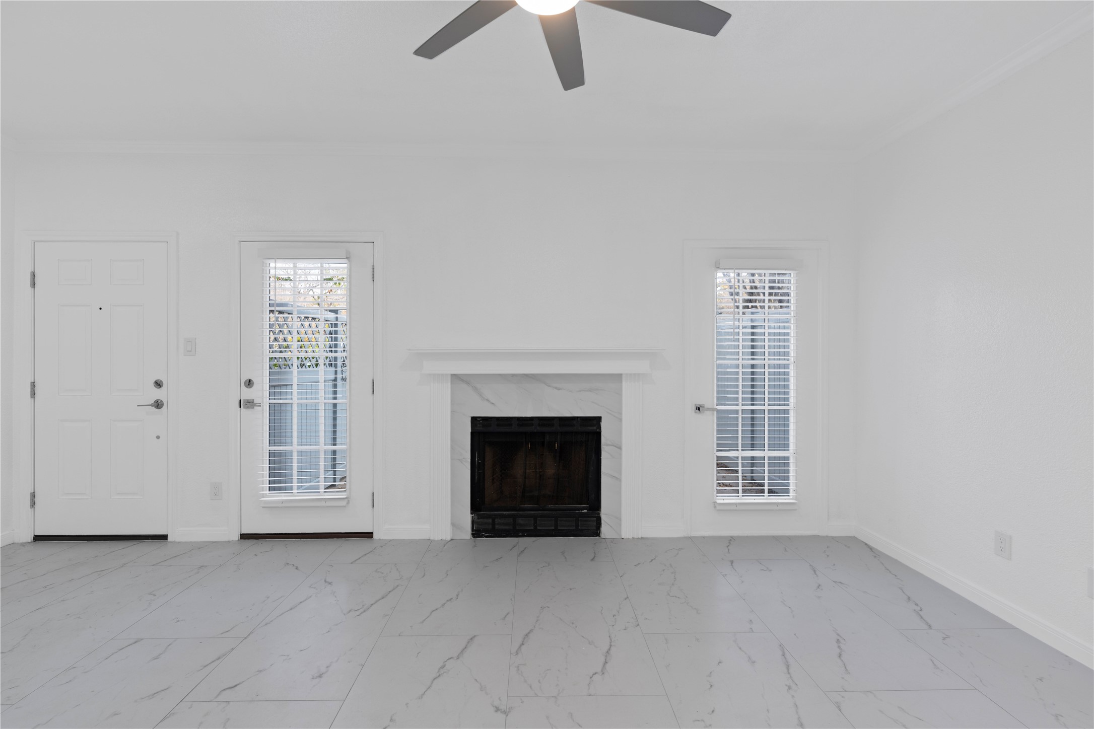 6000 Reims Road, Unit 2005 Houston, TX 77036 - Photo 11 of 28 an empty room with windows fireplace and cabinet