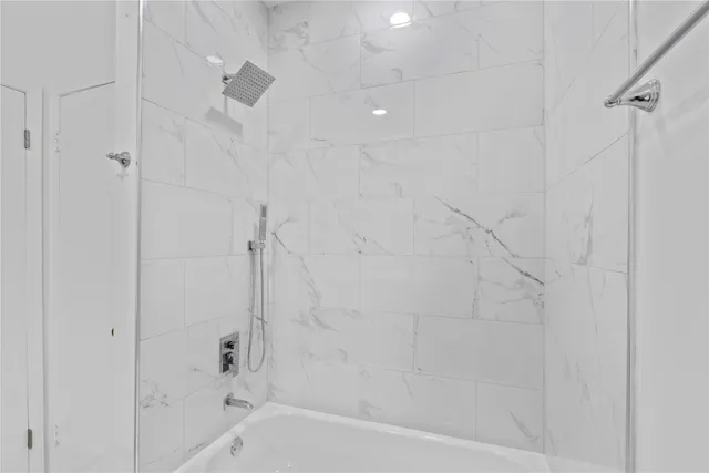 a bathroom with a shower and a bathtub