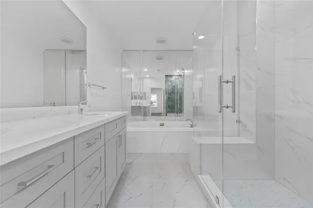 a bathroom with a granite countertop sink mirror and shower