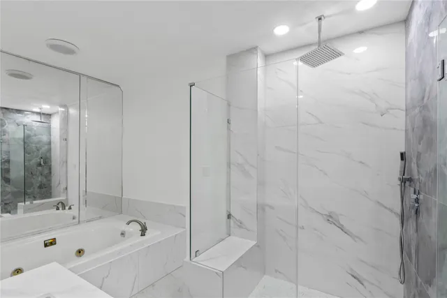 a bathroom with a shower a bathtub and a shower