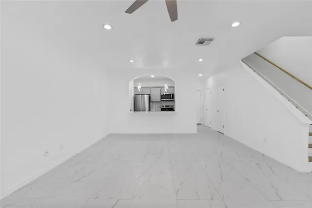 an empty room with a empty space and windows