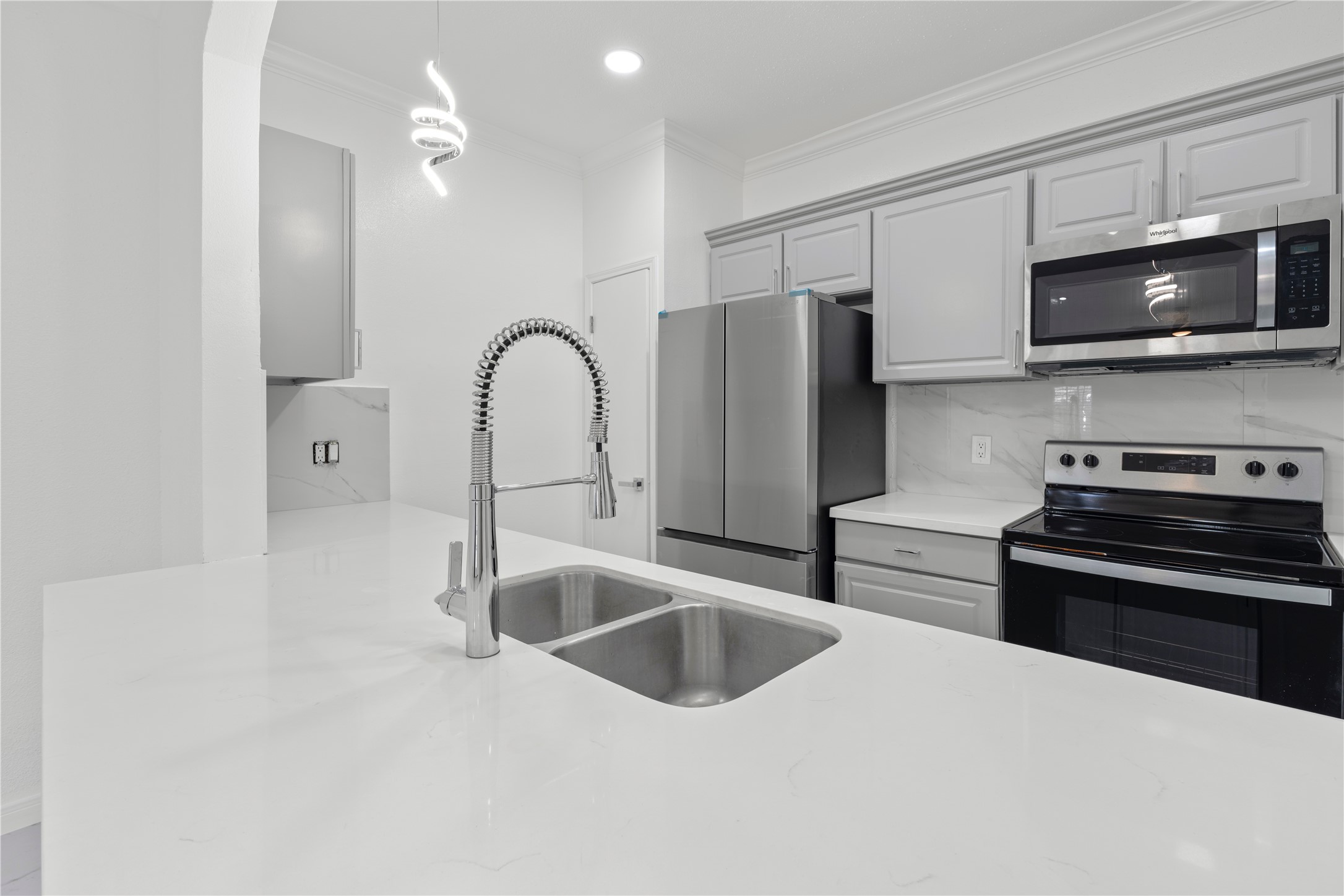 6000 Reims Road, Unit 2005 Houston, TX 77036 - Photo 5 of 28 a kitchen with stainless steel appliances a sink a stove and microwave