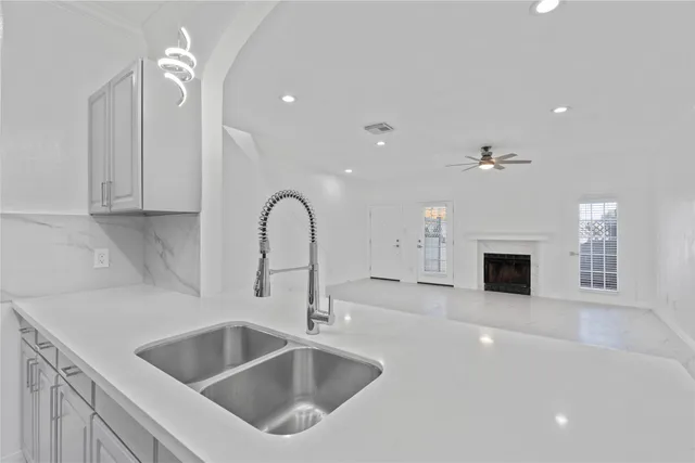 a kitchen with a sink and a fireplace