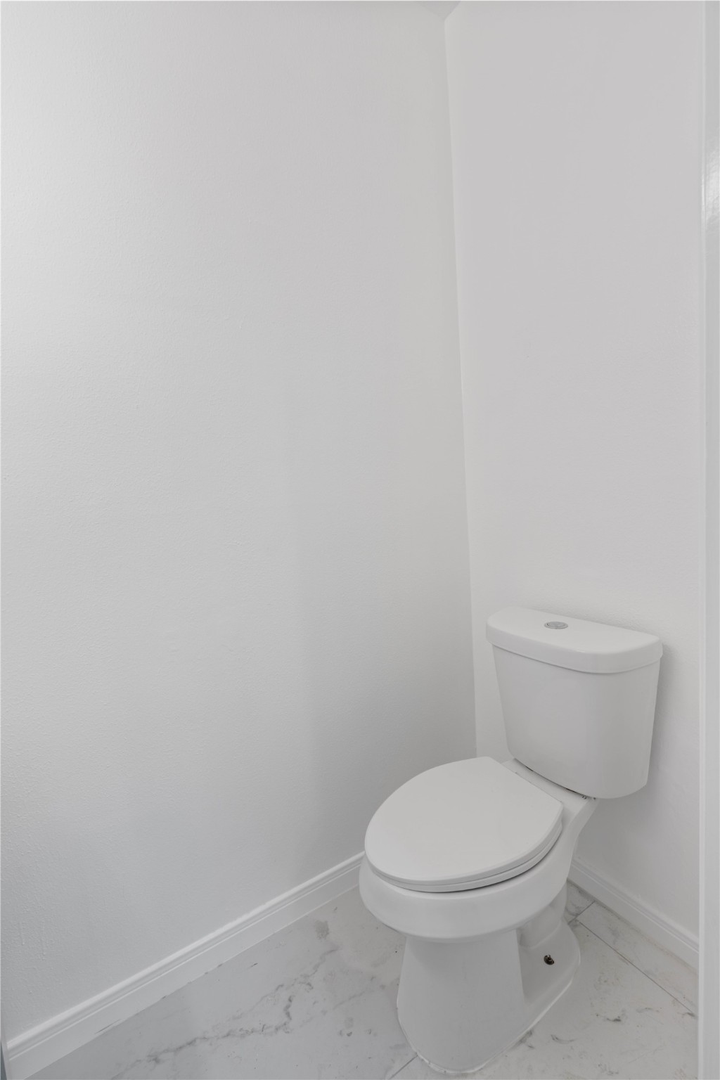 6000 Reims Road, Unit 2005 Houston, TX 77036 - Photo 9 of 28 a white toilet sitting next to a white wall
