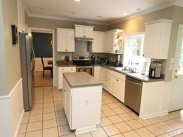 9805 Goodrum Court Raleigh, NC 27617 - Photo 4 of 17 This is a very nice kitchen with an island...lots of work space... white cabinets...appliances...SS appliances..it is waiting for the next "Great Cook".