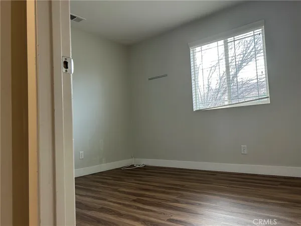 a view of a room with wooden floor and window