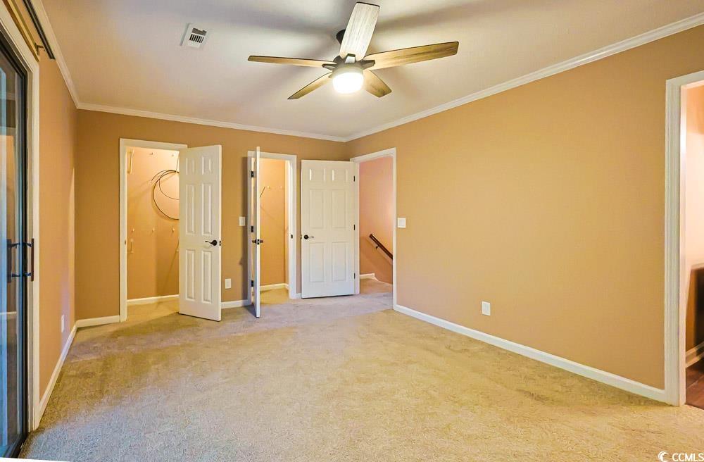 4840 Moss Creek Loop, Unit 3 Murrells Inlet, SC 29576 - Photo 12 of 40 Unfurnished bedroom with crown molding, ceiling fan, light carpet, and connected bathroom