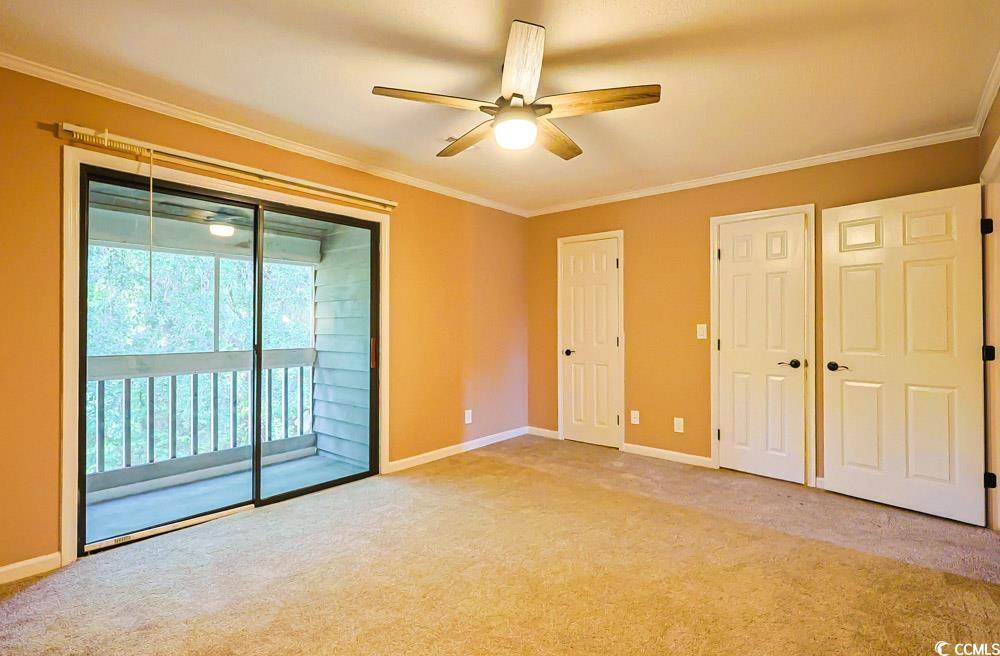 4840 Moss Creek Loop, Unit 3 Murrells Inlet, SC 29576 - Photo 14 of 40 Unfurnished bedroom featuring crown molding, multiple closets, access to exterior, carpet floors, and ceiling fan