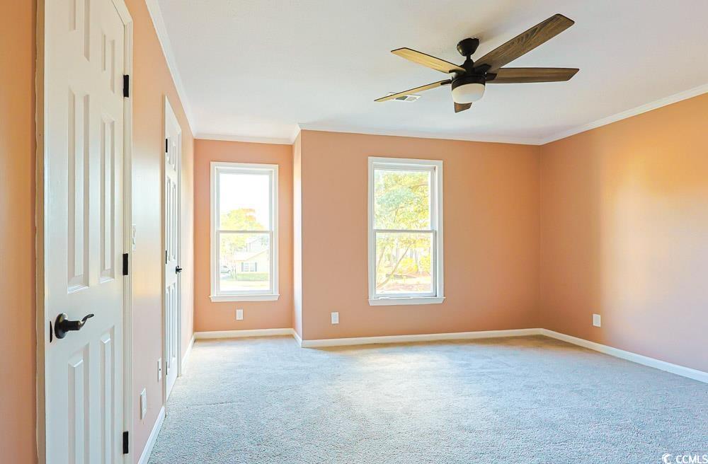 4840 Moss Creek Loop, Unit 3 Murrells Inlet, SC 29576 - Photo 20 of 40 Empty room featuring ornamental molding, light colored carpet, and a ceiling fan