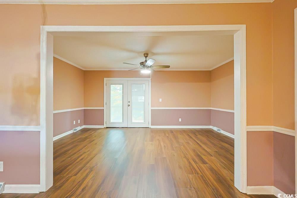 4840 Moss Creek Loop, Unit 3 Murrells Inlet, SC 29576 - Photo 2 of 40 Empty room with wood finished floors, french doors, ceiling fan, and crown molding