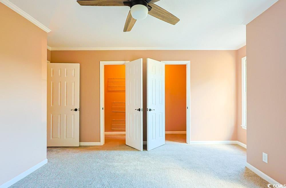 4840 Moss Creek Loop, Unit 3 Murrells Inlet, SC 29576 - Photo 25 of 40 Unfurnished bedroom featuring light colored carpet, ceiling fan, and crown molding