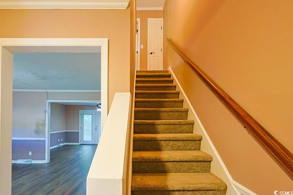 4840 Moss Creek Loop, Unit 3 Murrells Inlet, SC 29576 - Photo 27 of 40 Stairs with ornamental molding and wood finished floors