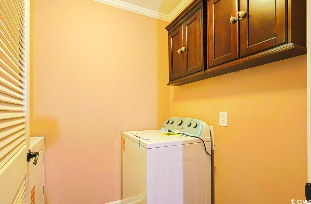 4840 Moss Creek Loop, Unit 3 Murrells Inlet, SC 29576 - Photo 29 of 40 Laundry room featuring ornamental molding and cabinet space