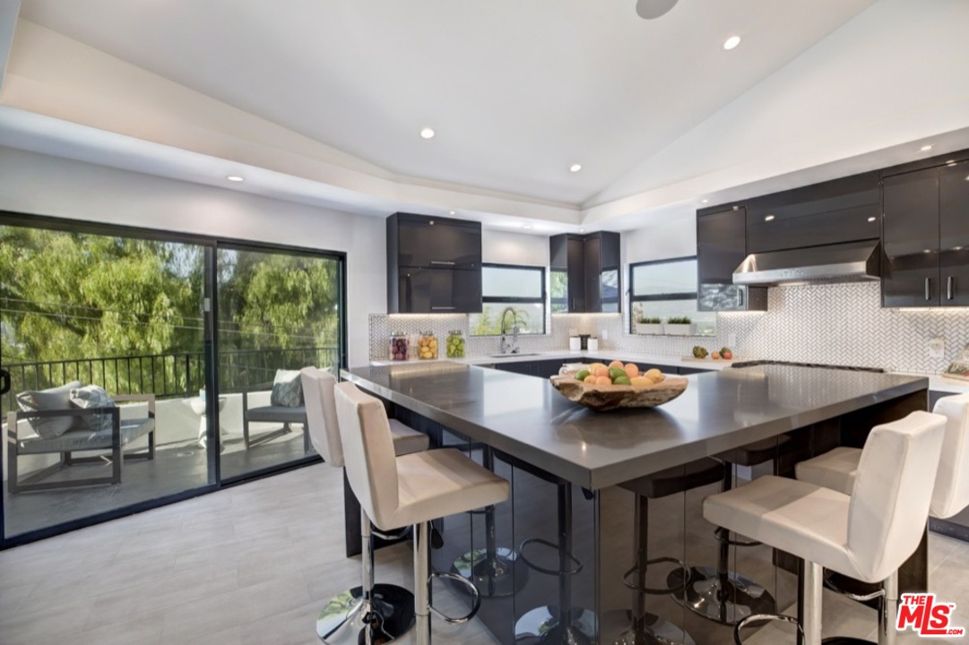 3712 Berry Drive Studio City, CA 91604 - Photo 5 of 50 a kitchen with stainless steel appliances a table and chairs in it