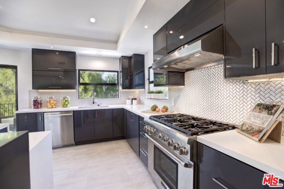 3712 Berry Drive Studio City, CA 91604 - Photo 6 of 50 a kitchen with stainless steel appliances granite countertop a sink stove and cabinets