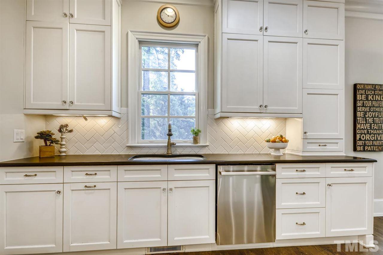 2827 Lewis Farm Road Raleigh, NC 27607 - Photo 11 of 30 Under Cabinet Lighting Highlights the Timeless and High Quality White Shaker Cabinets and Backsplash and Hardware.